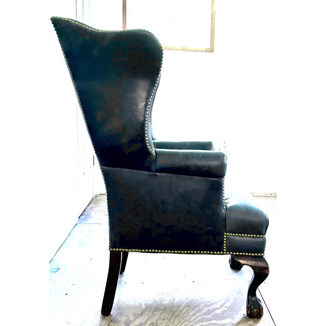Handsome generously proportioned mahogany wingback chair upholstered in beautiful, supple sapphire blue leather. Finished...