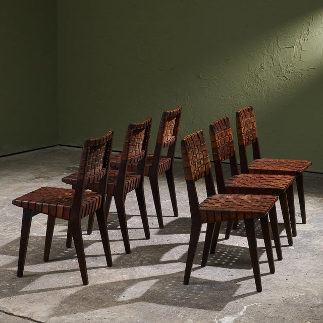 This set of six dining chairs by Jens Risom, made in the 1940s–1950s, features a frame in dark-stained solid oak with...