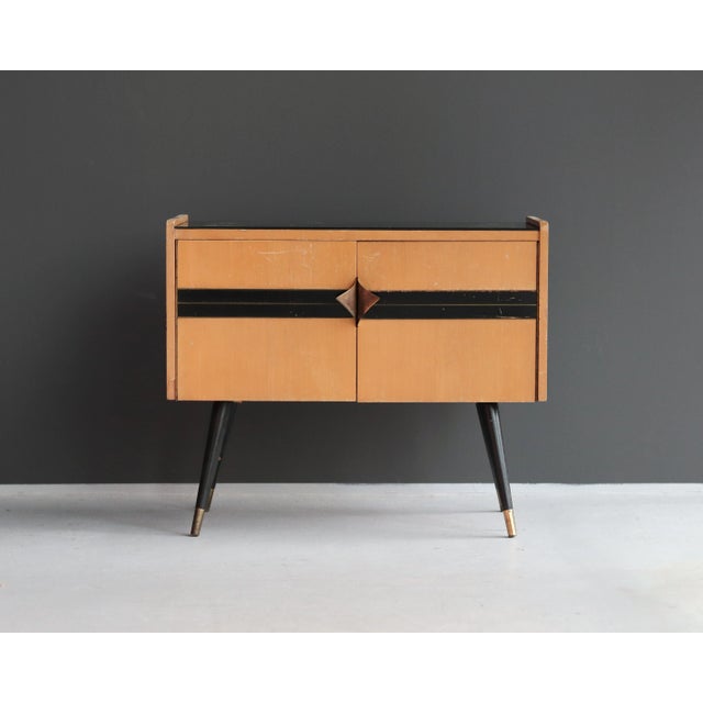 A stylish bedside or end table, commonly referred to as a "Patyczak," produced by the German firm Diele&Flur in the late...