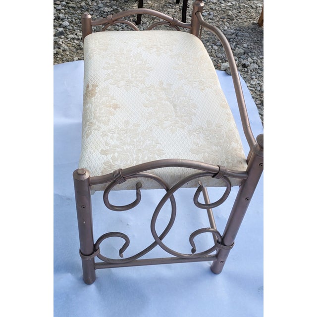 This is a sturdy stylish bronze bench/vanity with a cushion. You could put it in a bathroom, bedroom, or living room area....