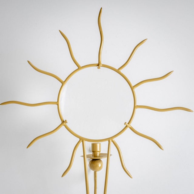 A pair of Soleil wall appliqués with space for one candle and a convex glass panel with a sun motif. The glass panel...