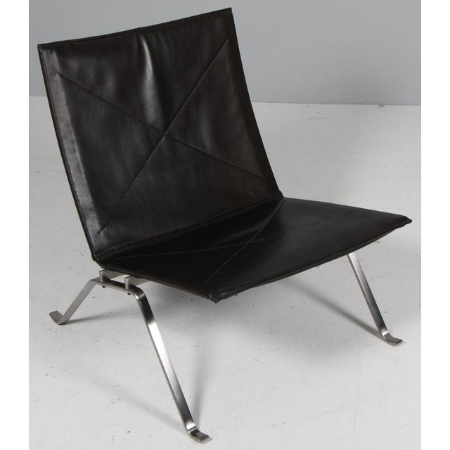 Poul Kjærholm lounge chair in patinated black ful grain aniline leather. Frame of brushed steel. Model PK22, made by Fritz...