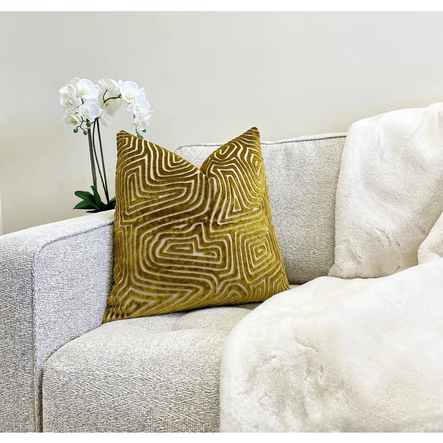 Add some pizzazz to your decor with this luxurious gold velvet pillow. The gold cut velvet maze pattern is set on a cream...