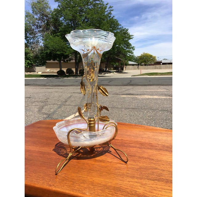 An exquisite vintage epergne showcasing romantic Venetian and Hollywood Regency influences, this sculptural centerpiece...