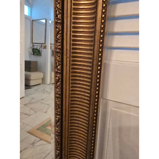 A true vintage original mid century modern designer gilded gold leaf mirror. Having a deep dimensional ridged and beaded...