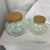 Set of 2 melon form apothecary jars with cork lids. Marked made in Italy. Large measures 9” diameter x 7.75” h. Small...