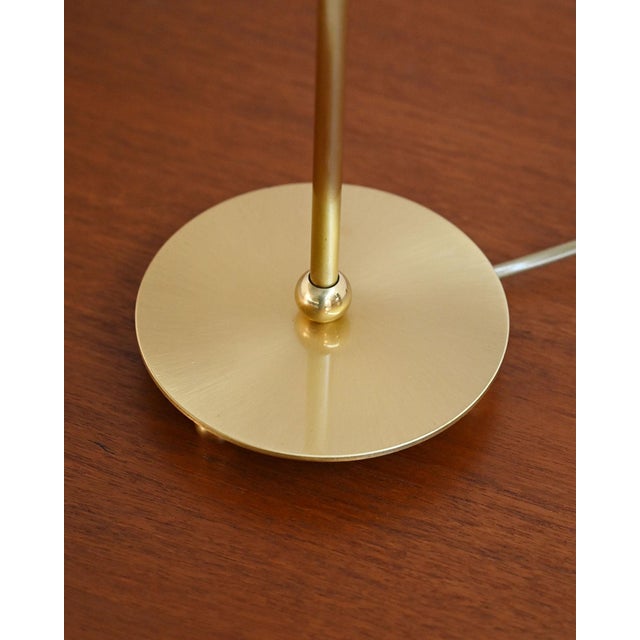 Circular base and brass stem paired with a pleated checked fabric lampshade. Scandinavian production, 1950s. A...