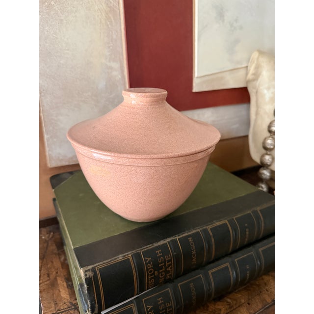 A warm, understated piece of mid century American stoneware in a soft blush tone with fine chocolate brown speckling...