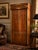 A striking vintage Mastercraft media armoire featuring richly figured walnut veneer, solid brass architectural detailing,...