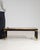 A distinctive mid-century coffee table featuring a glass top enclosing a sculptural relief motif, complemented by wood and...