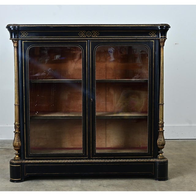 This 19th-century French bibliotheque is petite yet stately. It is an exceptional example of the Empire style with its...