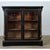 This 19th-century French bibliotheque is petite yet stately. It is an exceptional example of the Empire style with its...