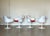Four Tulip chairs with armrests by Eero Saarinen for Knoll, 2017, with a heavy, molded, painted aluminum swivel base and a...