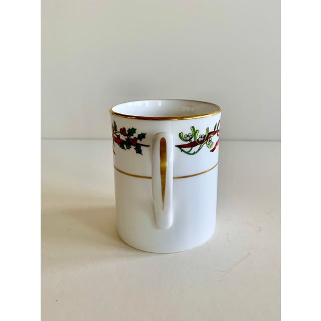 How pretty is this? Christmas red ribbons and holly leaves with berries wind themselves all around this English china mug....