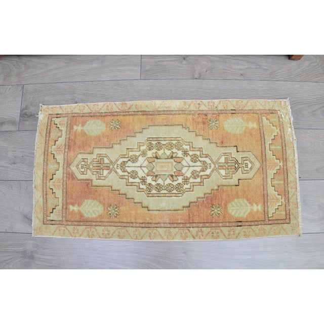 This is a vintage Turkish Oushak rug from the 1960s. The piece was hand-knotted.