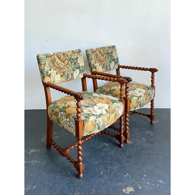 This elegant pair of vintage armchairs, designed in the celebrated Dorothy Draper style, showcases the theatrical...