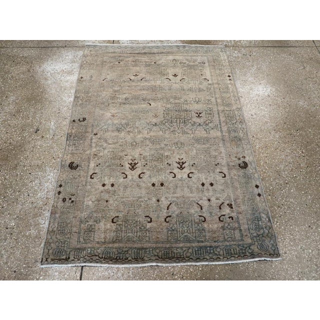 This mid-20th-century Persian Malayer throw rug presents a restrained and softly articulated composition in warm beige,...