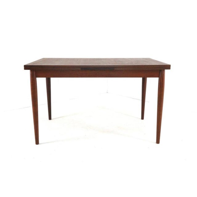 Extendable dining table with a warm teak finish. This beautiful dining table is in neat, restored condition, ready for...