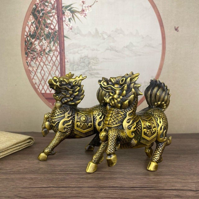 This striking pair of gilt bronze statues depicts Qilin, mythical hooved creatures from traditional folklore, captured in...
