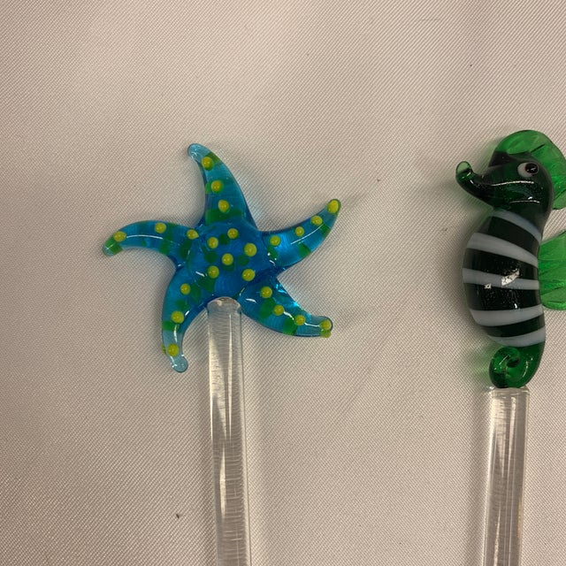 Offered here is a set of six handcrafted glass swizzle sticks featuring colorful ocean-themed sea life and fish toppers.