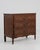 A Louis XVI chest of drawers featuring straight lines and classical detailing. The piece includes a rectangular case with...