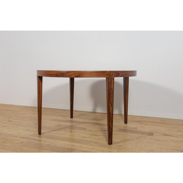 This round extending dining table was designed by Severin Hansen for the Danish furniture manufacturer Haslev...