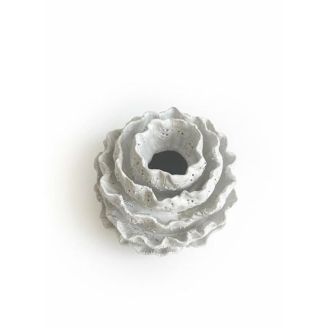 Contemporary ceramic sculptural vessel with a textured, tiered silhouette and organic, biomorphic form. Finished in a...