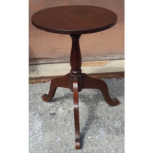 A 19th-century candle stand or small tea table or wine table featuring a circular mahogany top supported by a central...