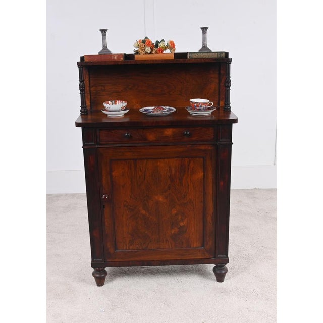 Elegant English Regency side cabinet or small chiffonier in richly figured mahogany The upper section with a raised...