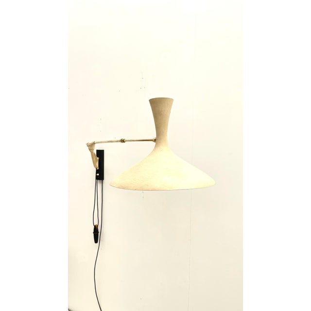 This rare mid-century wall lamp by Louis Kalff was made by Gebrüder Cosack Leuchten in Germany and is in perfect original...