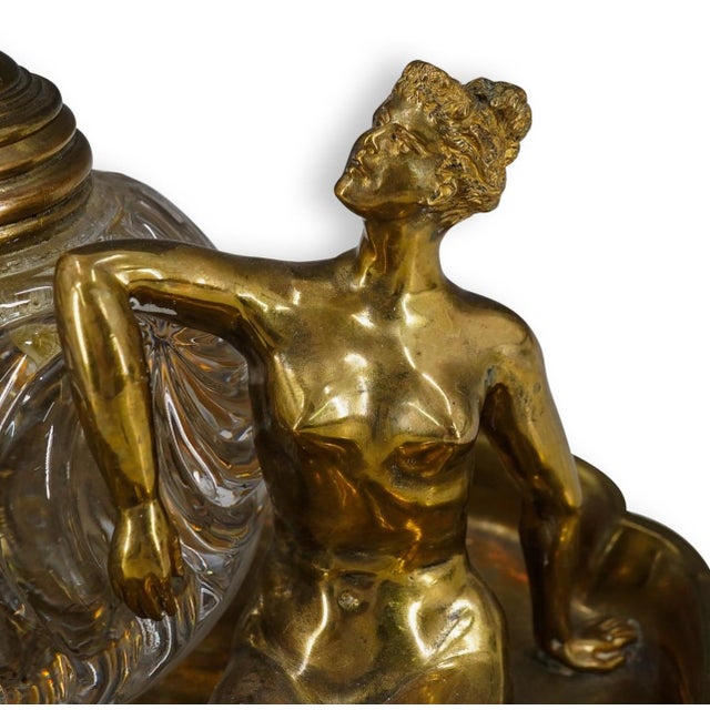 Antique inkwell, depicts two nude women, one sitting down with her legs outstretched, the other leaning on the ribbed...