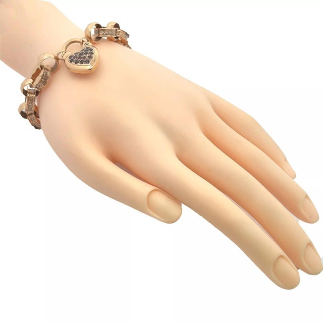 This beautiful vintage bracelet is crafted from 14k rose gold featuring 5mm wide oval links with flat edge and scallop...