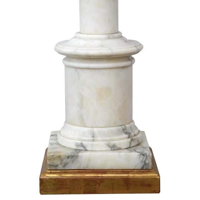 with giltwood neck above a turned columnar body of nicely figured Carrara marble all over a giltwood base; height 15.25"...