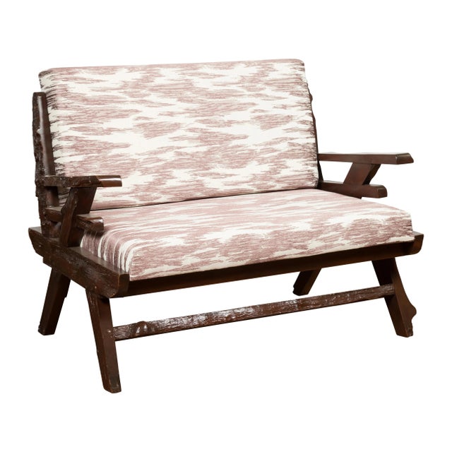 An antique Indonesian rustic wooden settee from the early 20th century, with natural edge, newly done custom upholstery...