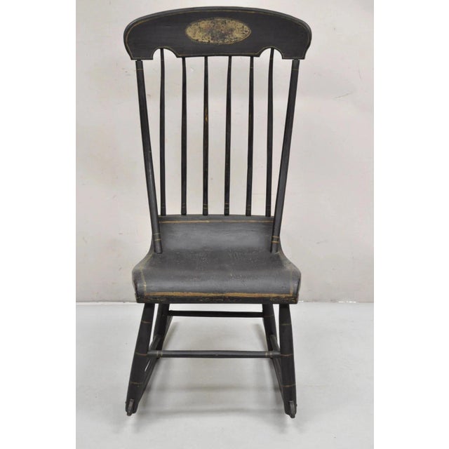 Antique Colonial Stencil Back Black Painted Plank Bottom Rocker Rocking Chair. Circa late 19th Century. Measurements: 40"...