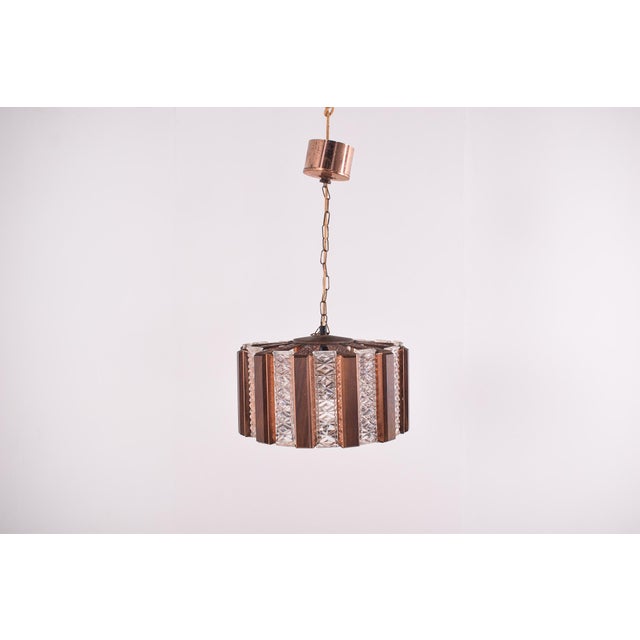 Scandinavian Modern ceiling lamp in brass, glass and teak. Round with alternating yellow and amber colored glass bricks...