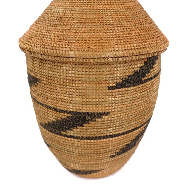 The Tutsi Tight Weave Basket with Lid from Rwanda epitomizes the artistry and tradition of the Tutsi community's weaving...