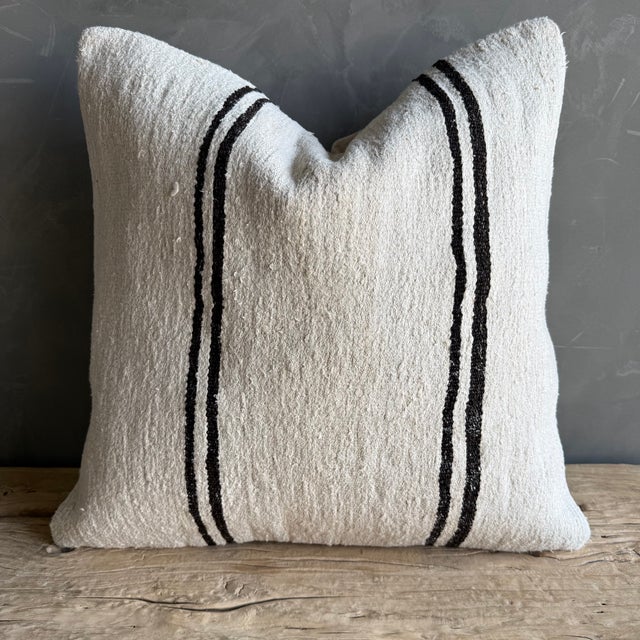 Creamy white hemp rug pillow with stripes. Soft hand, linen blend backing with zipper closure. Spot cleaning is...
