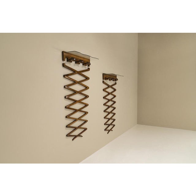 Unique pair of clothes hangers designed by Osvaldo Borsani for Arredamenti Borsani Varedo. These two coat racks were...