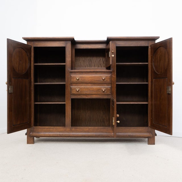 An imposing Art Deco oak sideboard dating from the early 20th century, recognizable by its geometric architecture and...