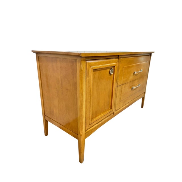 Bring timeless craftsmanship and functional design to your home with this vintage Heywood-Wakefield cabinet, crafted circa...