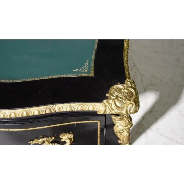 French empire style ebonized leather top writing desk. This beautiful desk is classic in design, featuring an embossed...