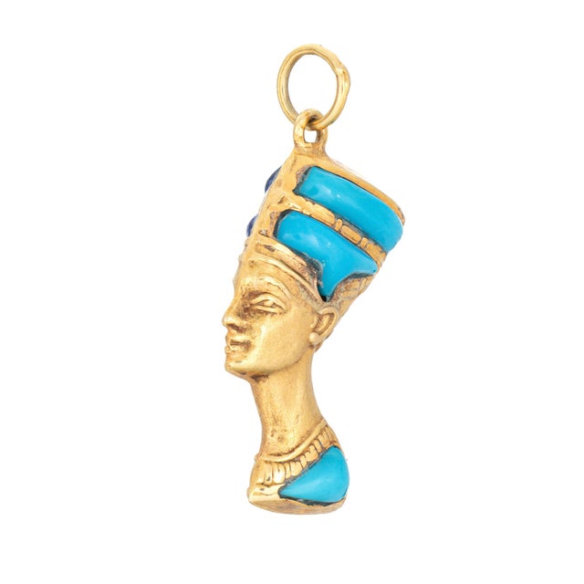 Finely detailed reversible Nefertiti charm crafted in 14k yellow & white gold. The sculptural portrait depicts Queen...