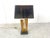 Sculptural brass table lamp in the manner of Alain Chervet. Beautfully sculpted brass base with a golden and black lamp...