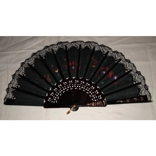 Hand made 14 stick hand fan with colorful hand painted flower motif on black background. Chairish sells electronic items...