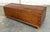 This antique pine chest features a gently domed lid, dovetailed construction, and a warm, timeworn surface with abundant...