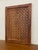 This decorative wooden lattice panel features a repeating geometric open work pattern set within a solid rectangular wood...