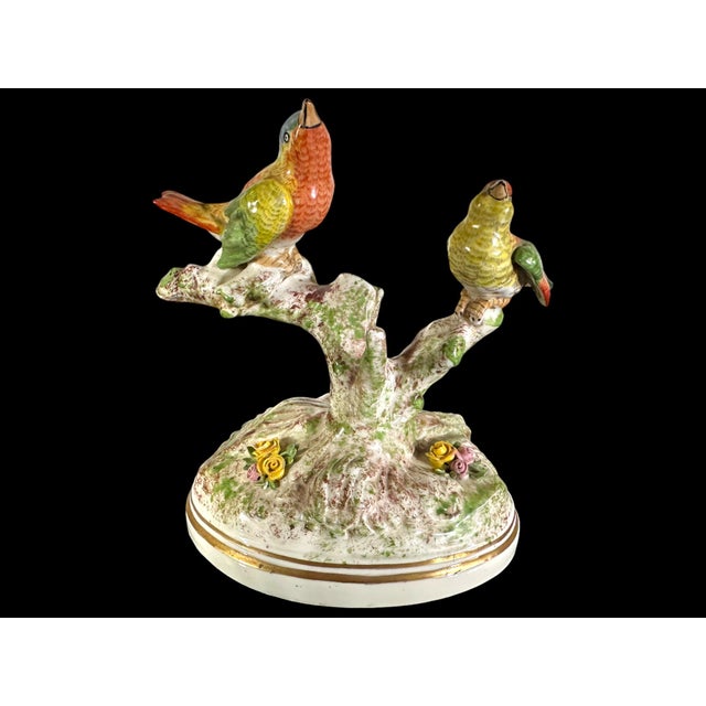 Pair of hand painted porcelain finches perched on branches. Both are marked "Made in France" to the underside along with a...