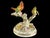 Pair of hand painted porcelain finches perched on branches. Both are marked "Made in France" to the underside along with a...