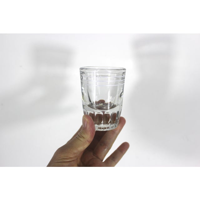 Fantastic vintage glass jigger that has white lines for 1 oz, 1 1/4 oz, 1 1/12 oz. The number markings and lines are...